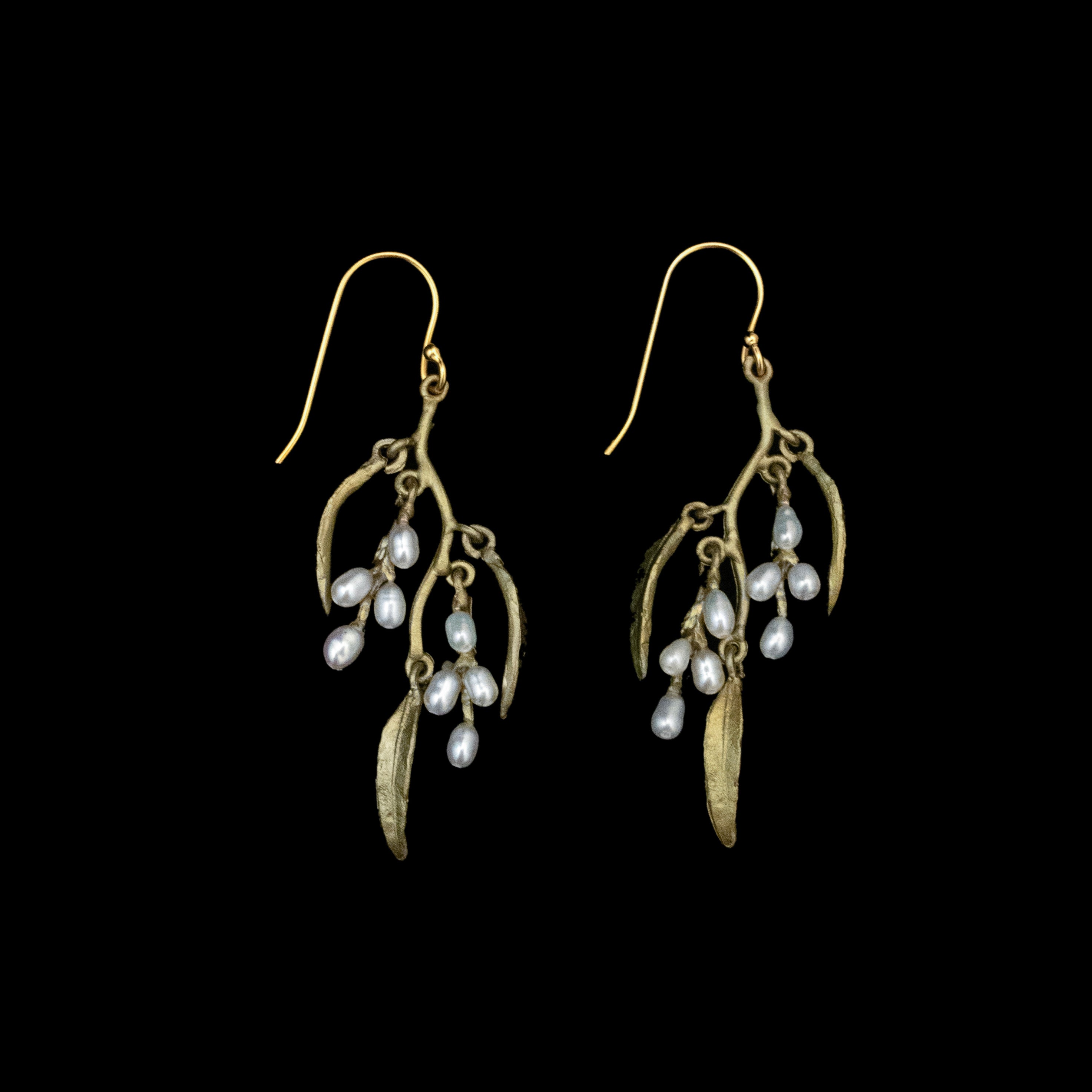Weeping Willow Earrings - Statement Wire feature green-colored branch shapes with elongated leaves and small freshwater seed pearls, beautifully displayed against a black background.
