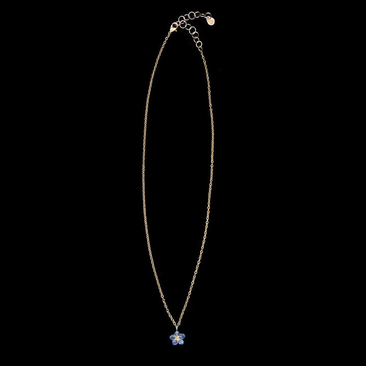 Necklace with a blue flower pendant on a black background